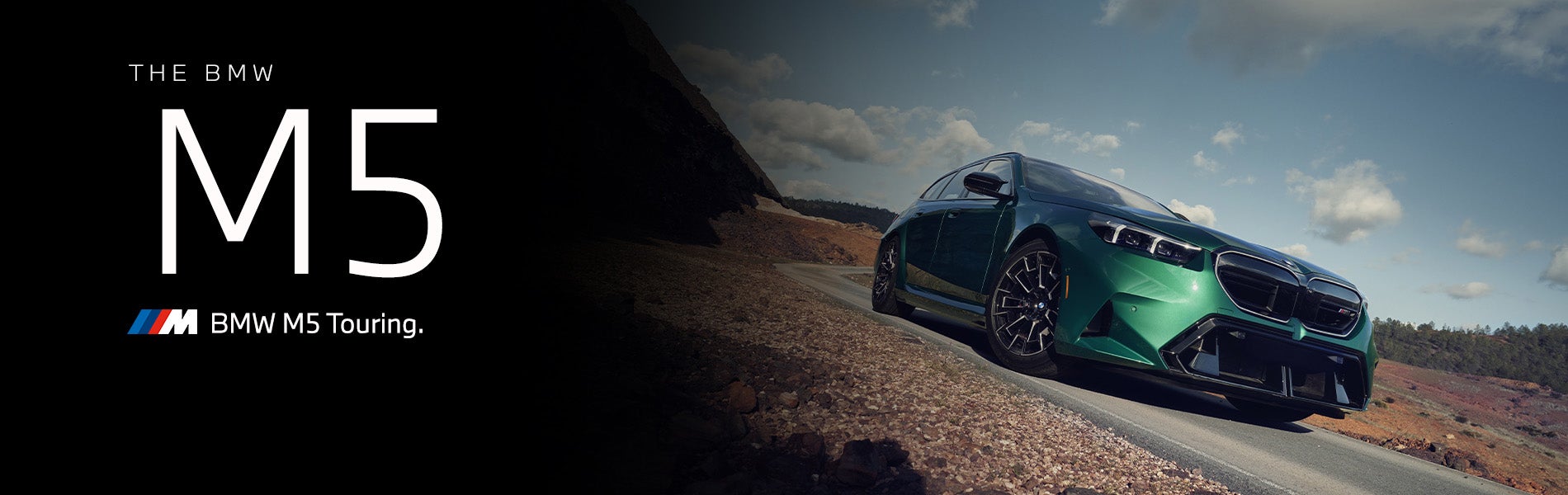 The new BMW M5 Touring in green driving down desert road | BMW of Portland in Portland OR