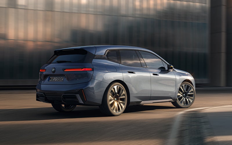 The BMW iX driving with the front wheel turned. | BMW of Portland in Portland OR